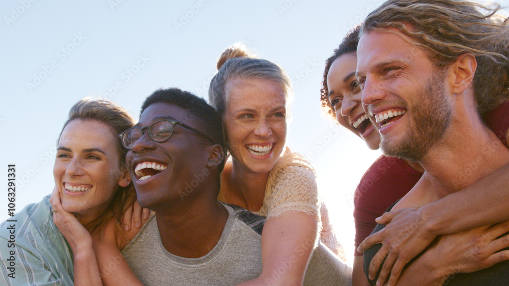 Close Up Of Couples Having Fun With Men Giving Smiling Women Piggybacks Outdoors