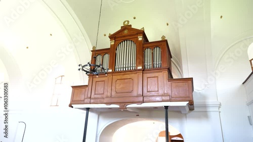 Wooden pipe organ in a reform church with bright natural lighting, Szalkszentmarton, Hungary photo