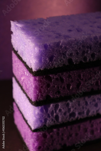 stylish dark sponges for washing dishes and cleaning on a purple background