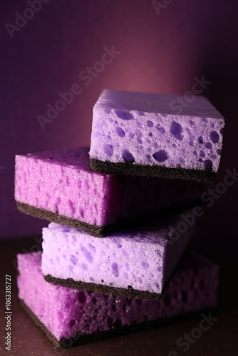 stylish dark sponges for washing dishes and cleaning on a purple background