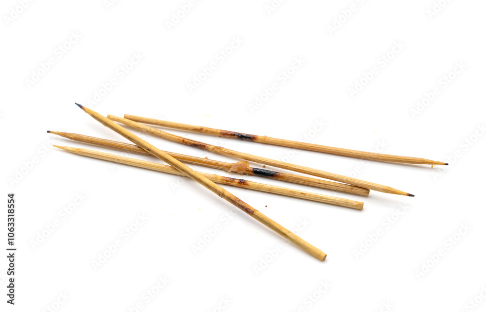 Leftover skewers of grilled pork sticks isolated on white background. Leftover skewers of grilled pork sticks isolated on white background.