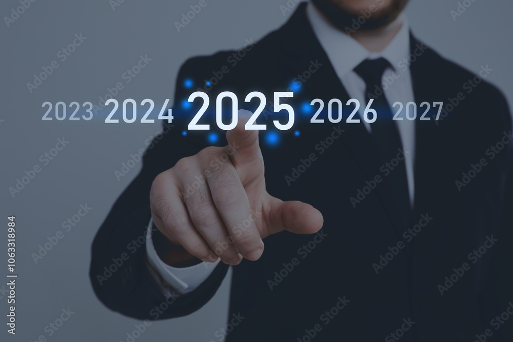 New year goals. Businessman touching 2025 on virtual screen against grey background, closeup New year goals. Businessman touching 2025 on virtual screen against grey background, closeup