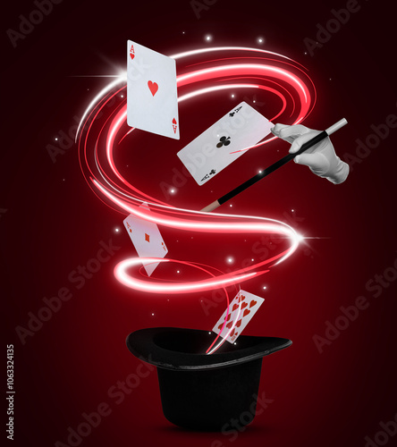 Magician showing trick with magic wand on red background. Playing cards and light flying out of top hat