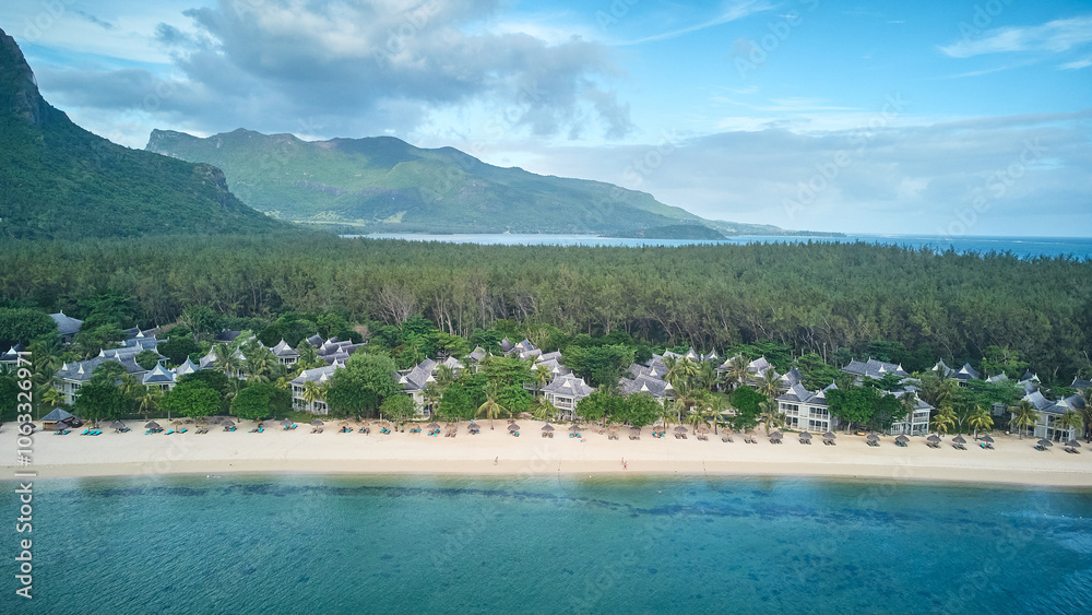 Le Morne tropical beach and famous kite, surf spot aerial panoramic view with palm trees and white sand blue ocean and sunbeds with umbrellas, Mauritius Le Morne tropical beach and famous kite, surf spot aerial panoramic view with palm trees and white sand blue ocean and sunbeds with umbrellas, Mauritius