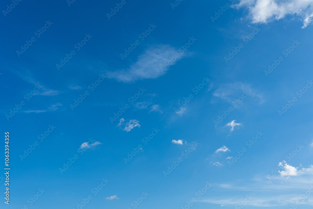 Fluffy white clouds drift across a brilliant blue sky Fluffy white clouds drift across a brilliant blue sky