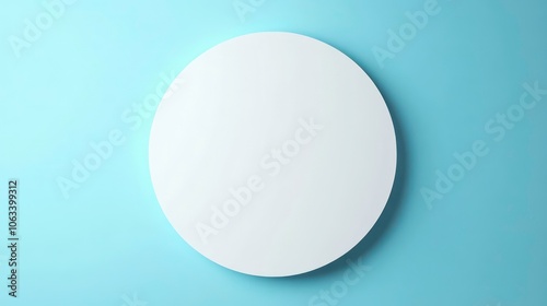 A minimalistic round mirror against a light blue wall, emphasizing simplicity and design.