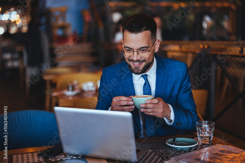 Businessman Enjoying Coffee While Working on Laptop in Café