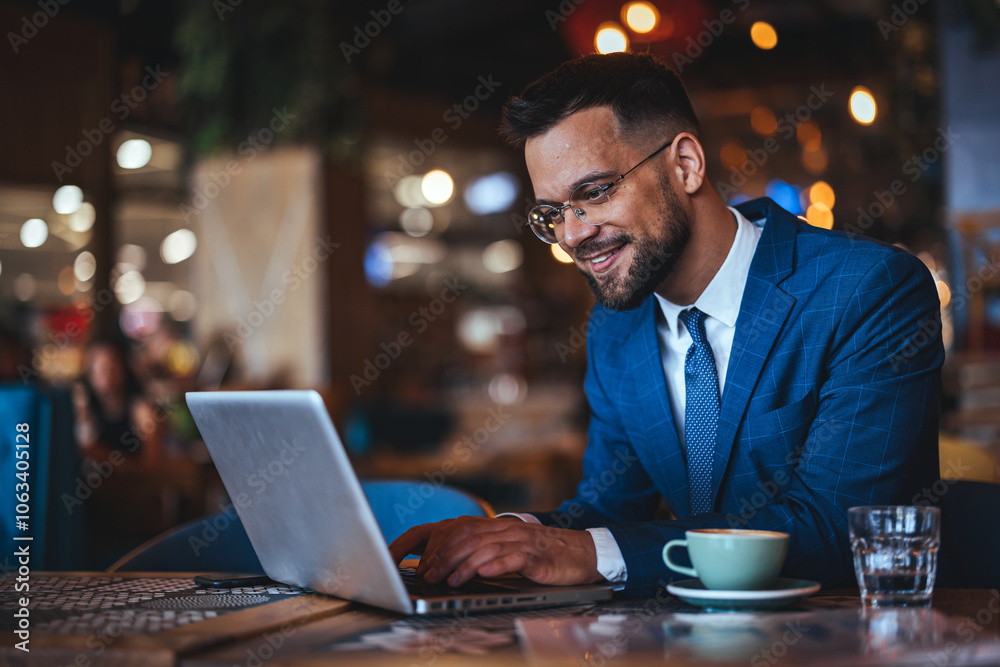 Businessman Working on Laptop in a Modern Cafe Setting Businessman Working on Laptop in a Modern Cafe Setting