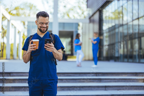 Smiling Medical Professional Texting Outdoors with Coffee photo