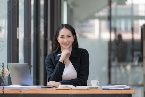 Asian businesswoman working with a laptop at the office.