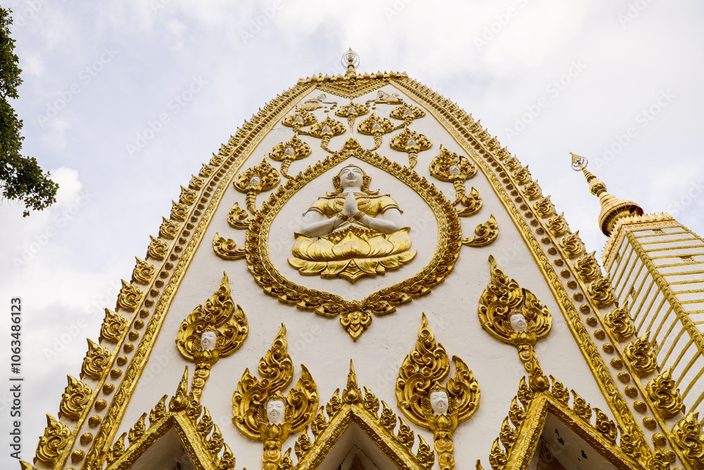 Wat Phra That Nong Bua, Ubon Ratchathani, inside there is the Phra That Sri Maha Bodhi Chedi, a replica of the Chedi in Bodh Gaya, India, stucco sculptures, candles, and two large Naga statues. Wat Phra That Nong Bua, Ubon Ratchathani, inside there is the Phra That Sri Maha Bodhi Chedi, a replica of the Chedi in Bodh Gaya, India, stucco sculptures, candles, and two large Naga statues.