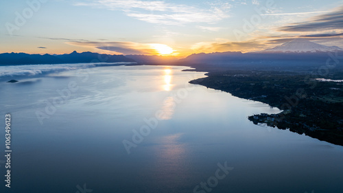 Aerial view of epic sunset in Lake Villarrica with amazing volcano as background. Araucania, Chile