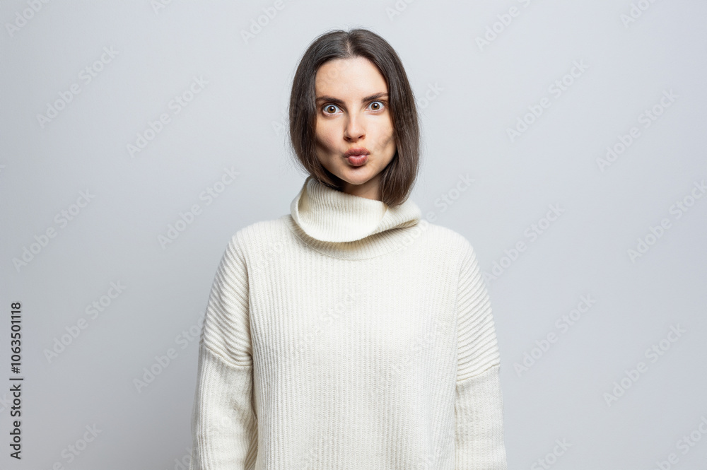 Beautiful funny woman doing some grimace looking at the camera. On white background. Beautiful funny woman doing some grimace looking at the camera. On white background.