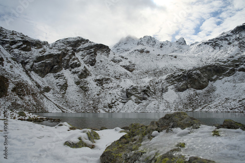 Mountain lake in the Swiss Alps in autumn, with snow-covered peaks. Lake Languard above Pontresina in autumn october  photo