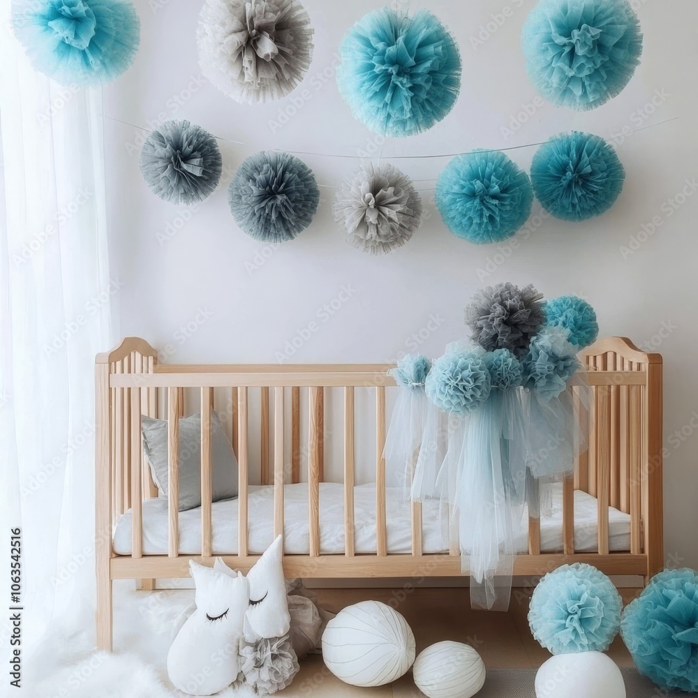 Obraz premium Tulle pompoms in blue and gray hang on crib