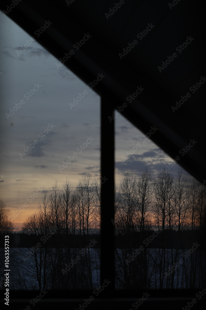 Fototapeta premium Sunset clouds mirrored in the window. Nature sunset sky backdrop. Blurry abstract sunrise background