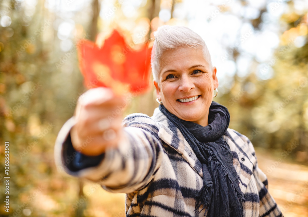 Mature woman in autumn forest, dressed in cozy fall attire, Reflection and connection with nature, wellness Mature woman in autumn forest, dressed in cozy fall attire, Reflection and connection with nature, wellness