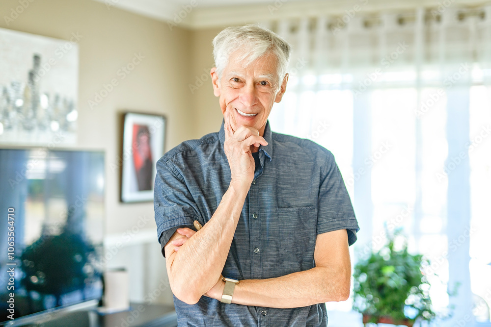 Portrait of retired senior man standing at home.