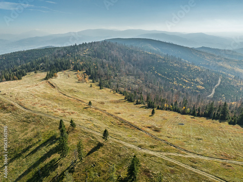 Beautiful sunny autumn in the Silesian Beskid.Aerial drone view of beskid mountains in autumn.Colorful autumn trees and forest in the mountains. Glinne, Radziechowska, Barania in the Polish Beskids. photo