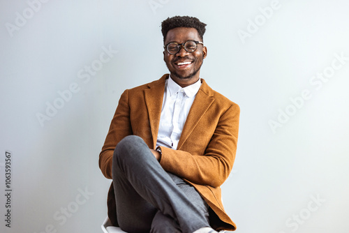 Confident Man Smiling in Stylish Business Attire Sitting on Chair photo