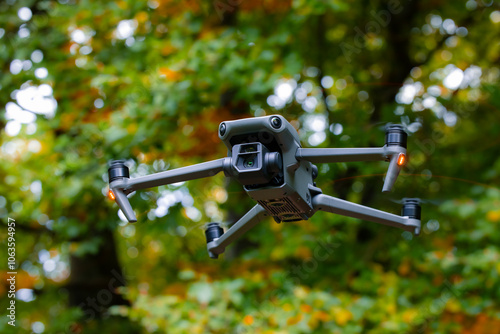 flying drone videography photography modern wireless technology equipment object close up outdoor natural view blurred foliage forest background with fuzzy propellers in motion