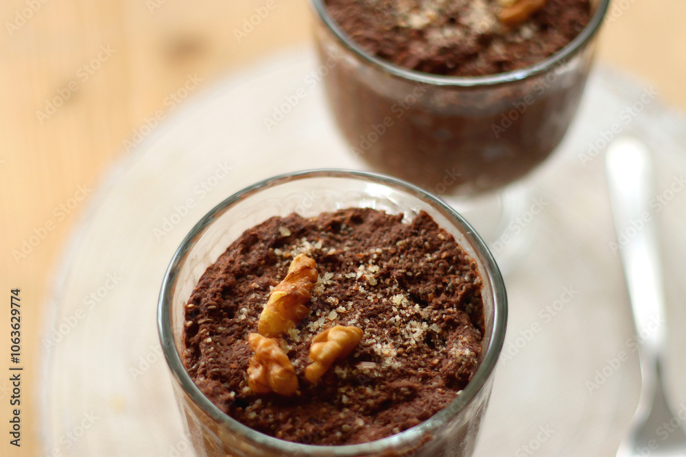 Two bowls of chia seed, chocolate and orange pudding. Healthy snack, wooden background. Selective focus. Two bowls of chia seed, chocolate and orange pudding. Healthy snack, wooden background. Selective focus.