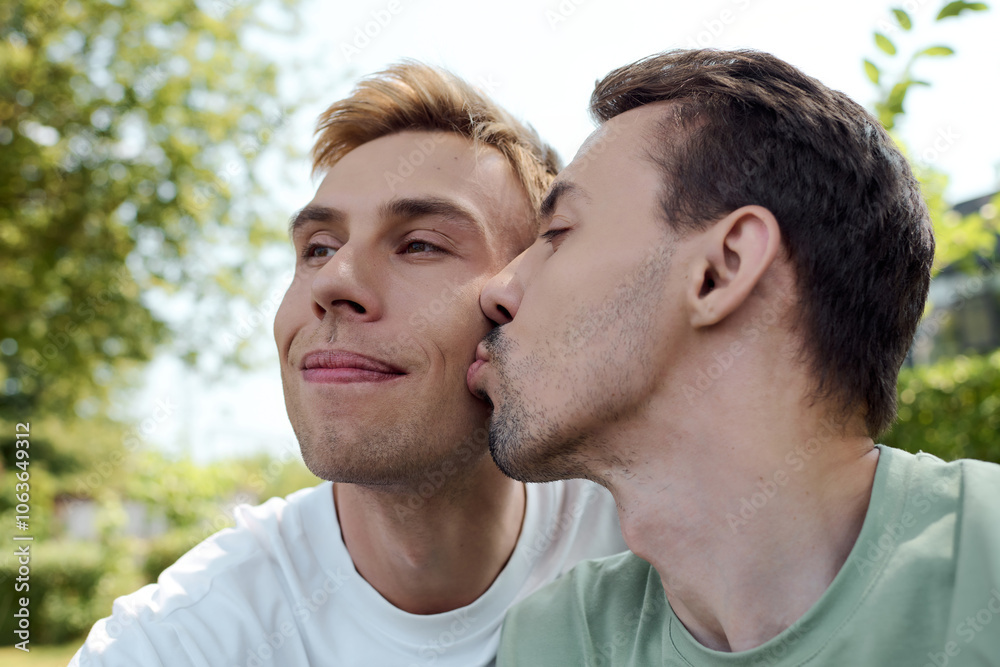 A joyful couple shares a loving kiss while enjoying a warm afternoon in a vibrant park. A joyful couple shares a loving kiss while enjoying a warm afternoon in a vibrant park.