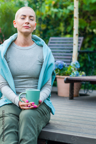 Cancer patient sitting on garden patio with coffee, eyes closed. Health insurance, medical expenses, loss of income safety plan. Mental health, wellbeingduring illness.