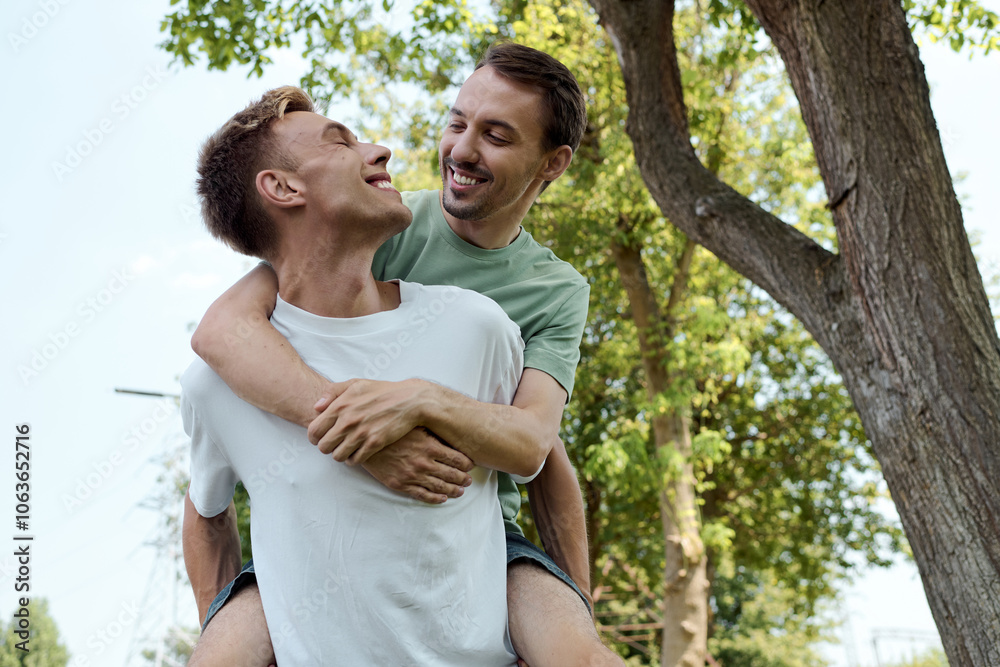 Fototapeta premium Two men celebrate a sunny day, playfully embracing and enjoying each others company outdoors.