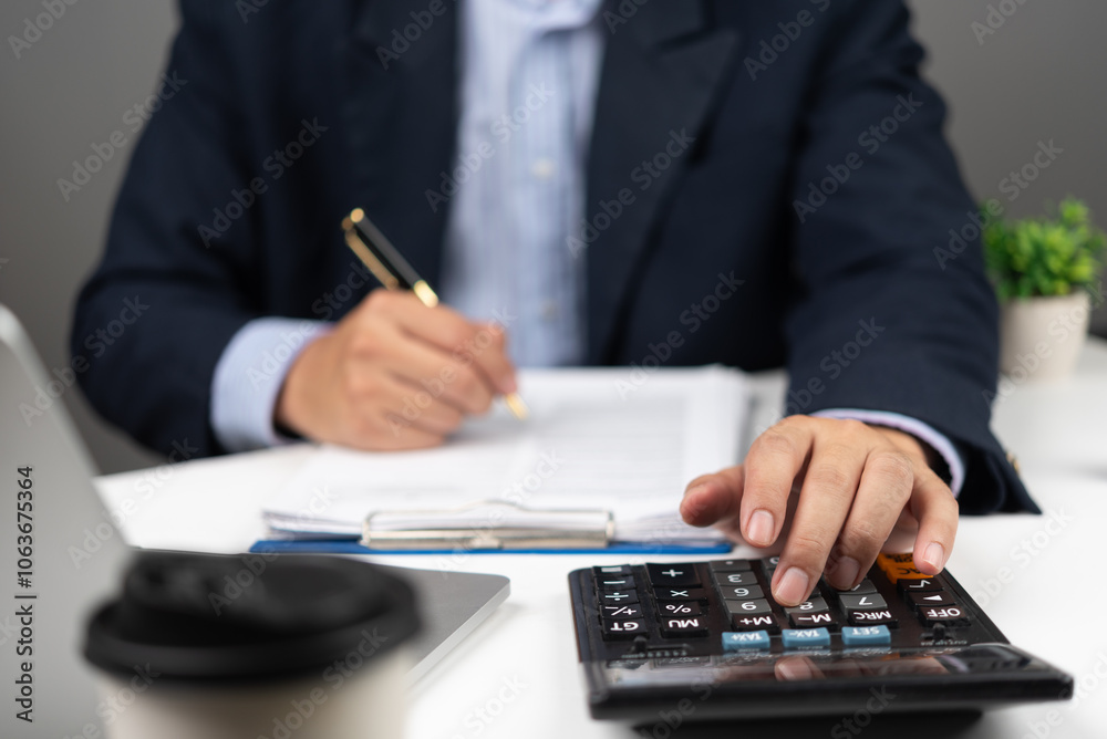 Businessman using calculator bookkeeping payroll and budget tax. Business document finance accounting investment