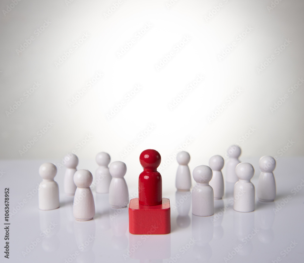 Leadership concept - red wooden figure leading other wooden figures reaching. Leadership concept Leadership concept - red wooden figure leading other wooden figures reaching. Leadership concept