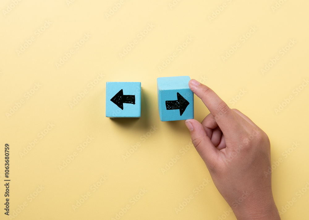 The hand that selects right among the wooden blocks marked with the left and right icon The hand that selects right among the wooden blocks marked with the left and right icon