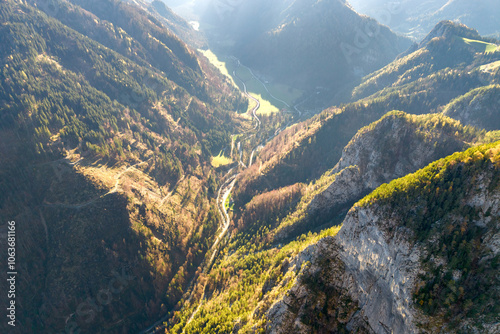 Aerial view of Logar Valley, Slovenia. Sunlight filters into a valley surrounded by a mountain range. Kamnik-Savinja Alps photo