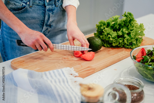 Cooking concept. Woman hands making healthy dinner, cutting vegetables on chopping board, kitchen interior, closeup