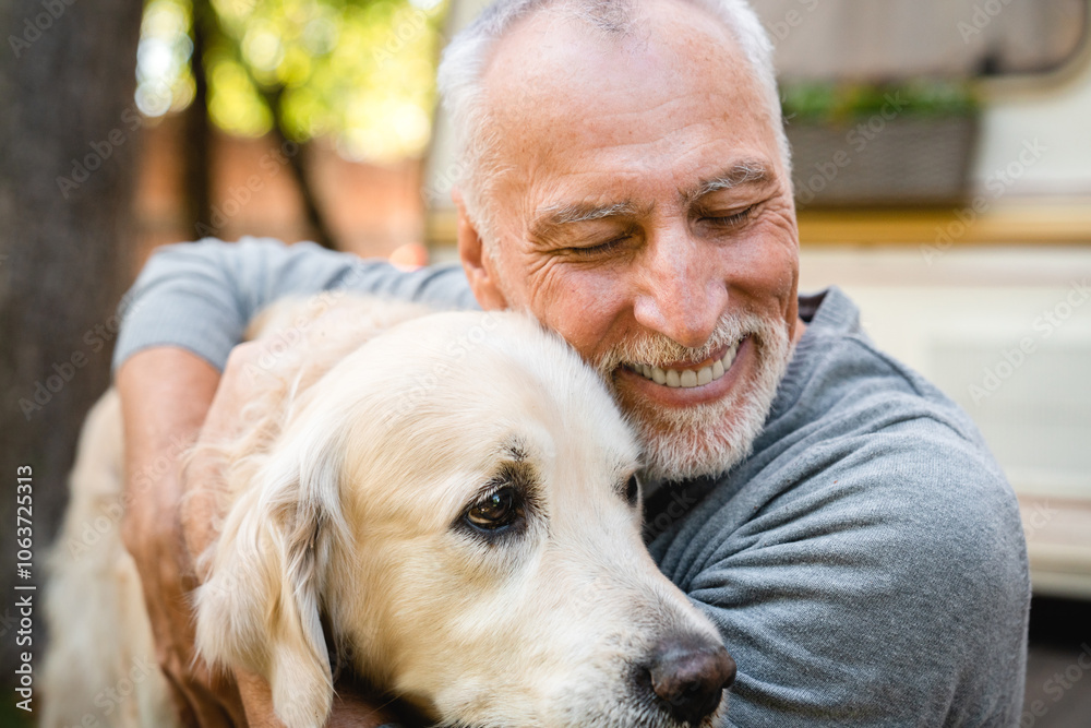 Emotionally supportive animal. Senior old man grandfather playing with his dog golden retriever Emotionally supportive animal. Senior old man grandfather playing with his dog golden retriever