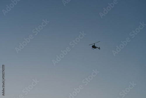 Helicopter on a clear blue gradient sky