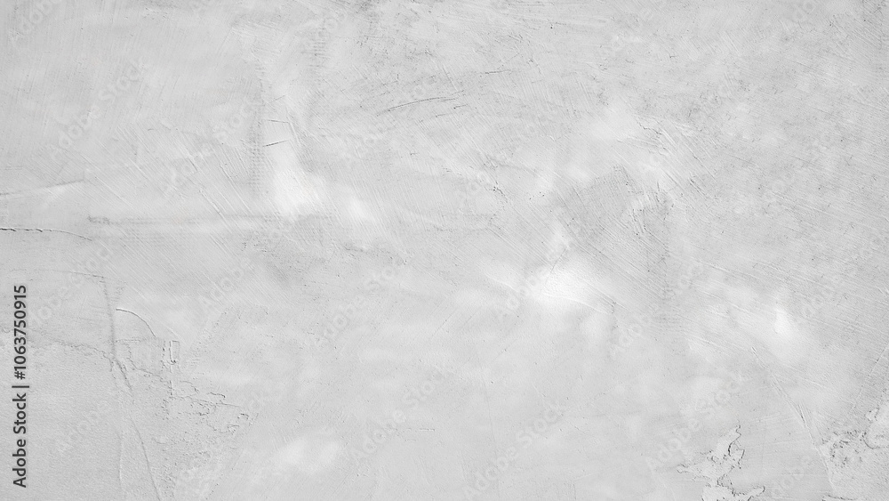 Naklejka premium A grey wall with a rough texture. The wall is covered in white paint and has a grainy appearance