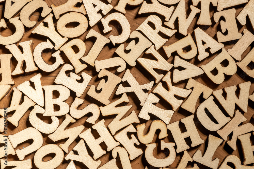 there are a lot of wooden letters on the brown surface there are a lot of wooden letters on the brown surface