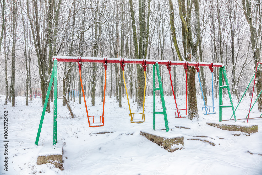 Empty swing in winter time with snow Empty swing in winter time with snow