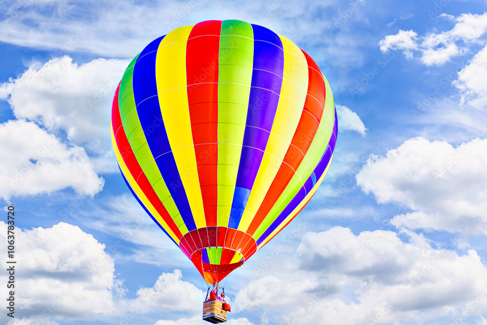 Fototapeta premium Colorful hot air balloon flying over blue sky with white clouds 