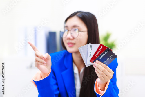 An Asian woman sits at her desk, surrounded by files , embodying dedication and professionalism in her work.