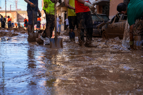 Photo shows the aftermath of the recent flood in Alfafar, Valencia, Spain. Captured are damaged homes, roads, submerged parking lots, and the efforts of residents and volunteers to clean and rebuild.