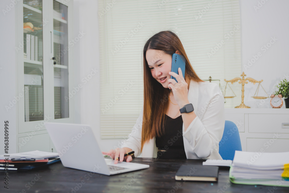 Asian businesswoman, focused , sits at ablack wooden table. Surrounded by notes , she strategizes her next move, embodying confidence and professionalism in her workspace. Asian businesswoman, focused , sits at ablack wooden table. Surrounded by notes , she strategizes her next move, embodying confidence and professionalism in her workspace.