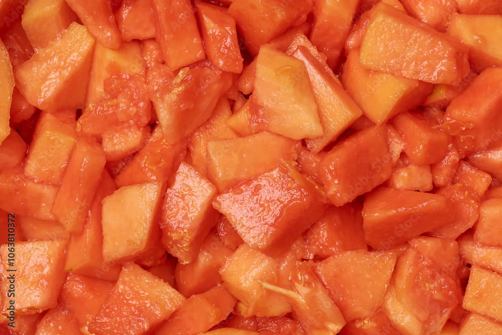 chopped of ripe papaya flesh, vibrant orange and red soft and juicy fruit pieces of tropical fruit to prepare mixed fruit salads or smoothies, food background chopped of ripe papaya flesh, vibrant orange and red soft and juicy fruit pieces of tropical fruit to prepare mixed fruit salads or smoothies, food background