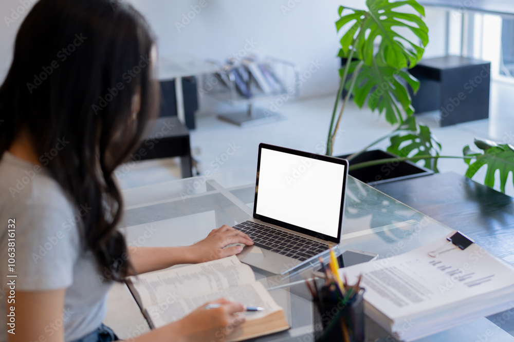 Woman using and typing on laptop with blank white screen. Mockup image blank white desktop screen Woman using and typing on laptop with blank white screen. Mockup image blank white desktop screen