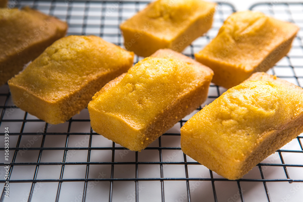 Close-up of corn muffins on plate with bowl of corn meal and additional muffins in the background. Close-up of corn muffins on plate with bowl of corn meal and additional muffins in the background.