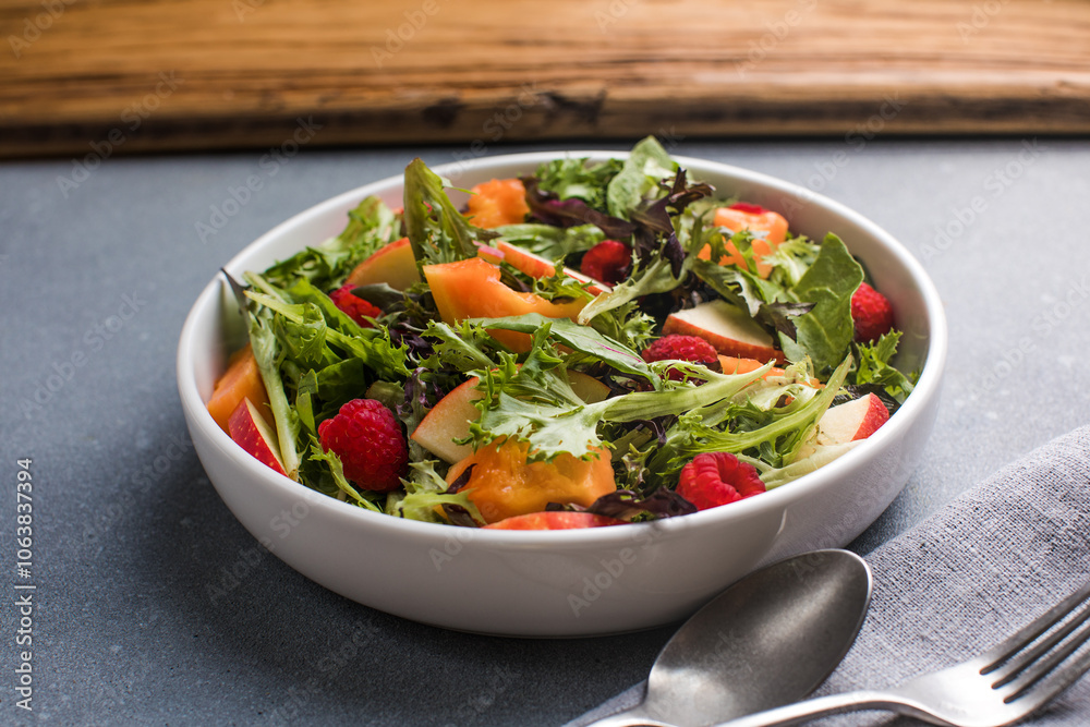 Fresh vegetable salad plate of papaya, leaves raspberry and apple. Healthy food. Diet dinner or lunch menu. Salad plate on table. Flat lay. Fresh vegetable salad plate of papaya, leaves raspberry and apple. Healthy food. Diet dinner or lunch menu. Salad plate on table. Flat lay.