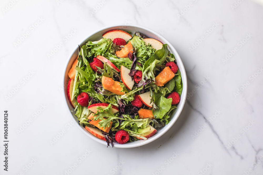 Tasty salad with apple, papaya, lettuce, top view. Vegetable salad. Tasty salad with apple, papaya, lettuce, top view. Vegetable salad.