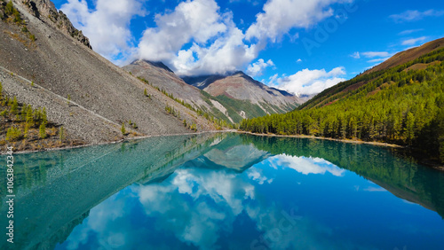 upper Shavlinskoye mountain lake in Altai in autumn with a view of the snow-dusted mountains photo