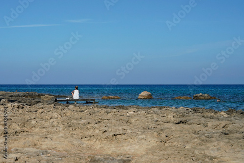 Girl on a Wooden Dock Gazing at the Turquoise Sea Horizon